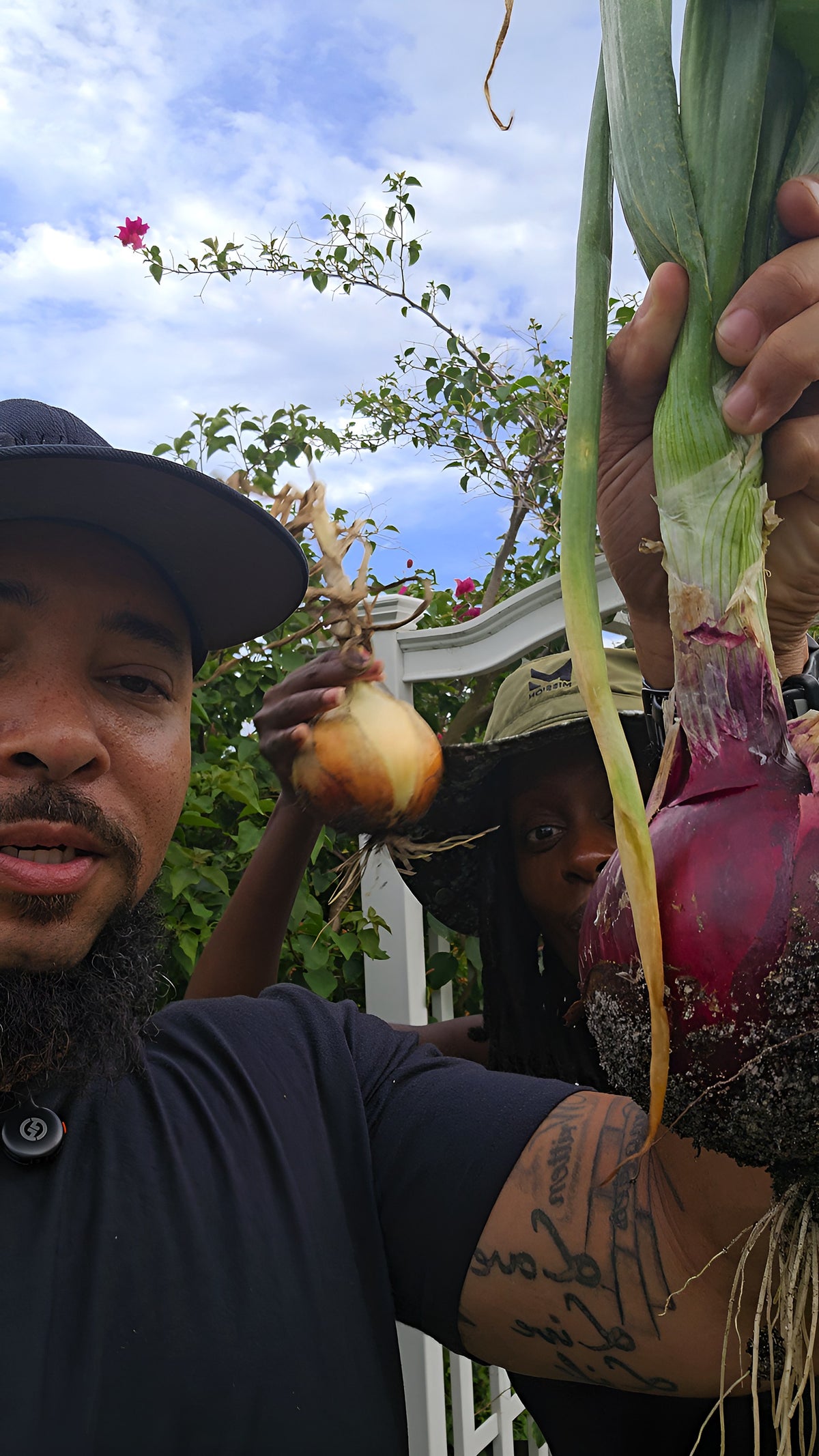 Jermaine and Toni Jefferson holding freshly harvested onions